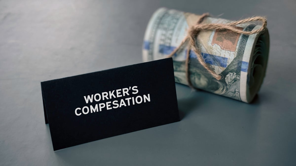 business and finance concept. tag written with worker's compensation next to a usd money