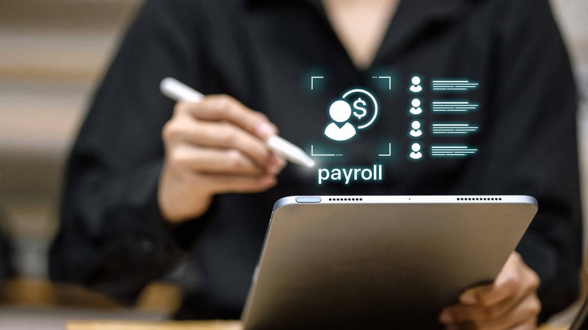 Business person using tablet with virtual payroll interface, employee list and dollar icon. Concept of salary management, human resources technology and digital payment.